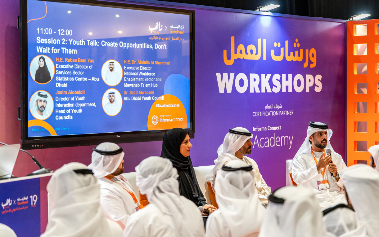 Emirati jobseekers attending a group counselling workshop at Tawdheef x Zaheb 2025, taking notes and engaging in practical career discussions.