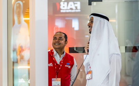 Emirati men and women walking around the center at Tawdheef