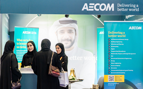 Emirati officer talking with Emirati man in wheelchair at Tawdheef
