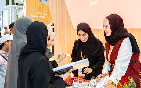Emirati men and women exploring Tawdheef center