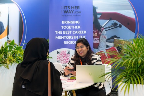 Career mentor offering personalised guidance to an Emirati jobseeker at Tawdheef x Zaheb 2025 in Abu Dhabi.