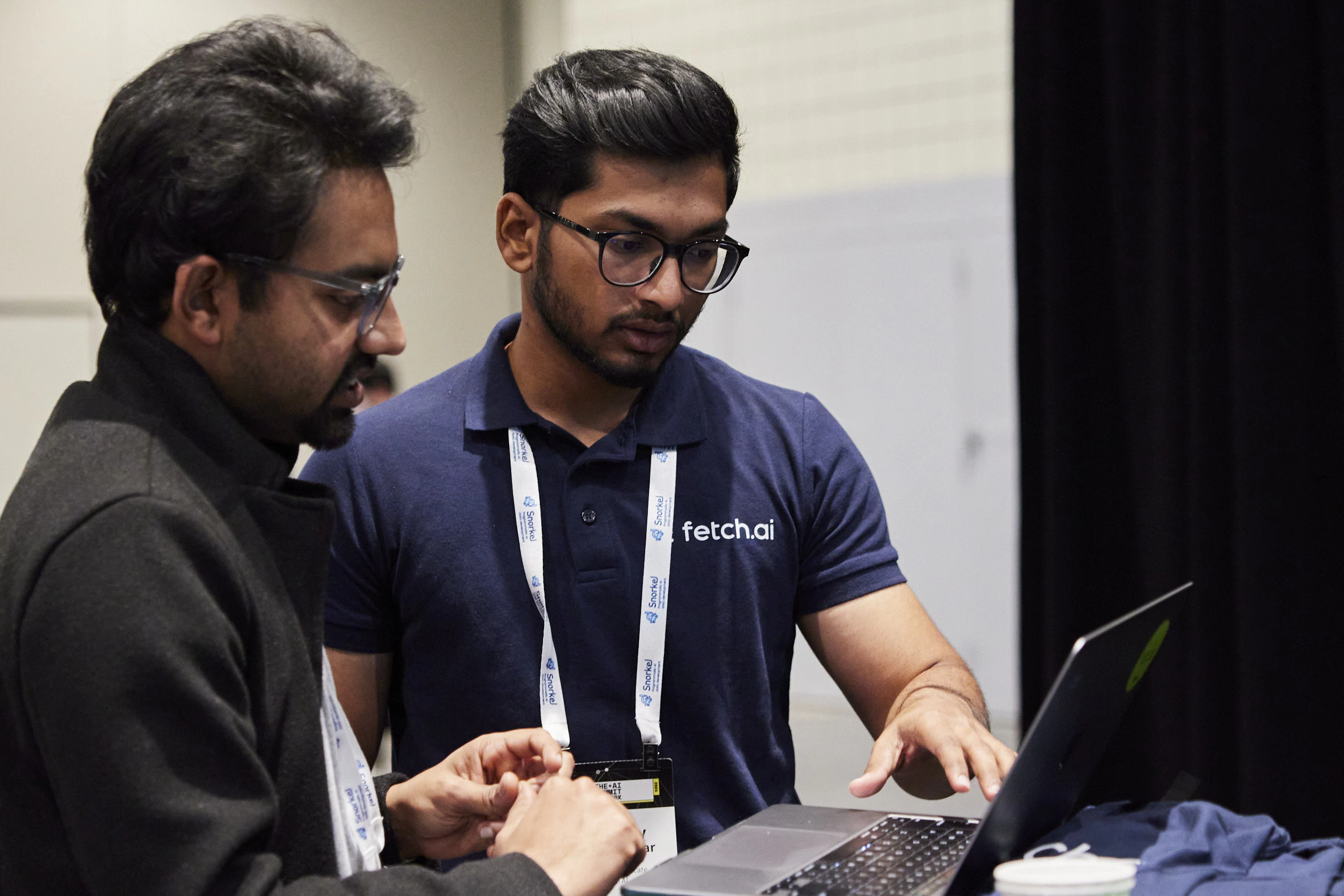 Attendees looking at laptop at The AI Summit New York
