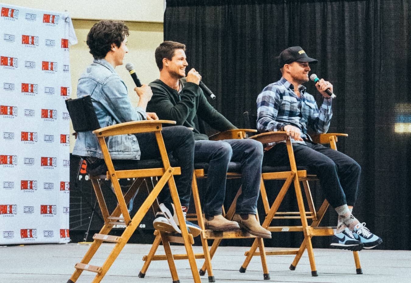 Stephen & Robbie Amell sit on stage with former Cineplex pre-show host Tanner Z