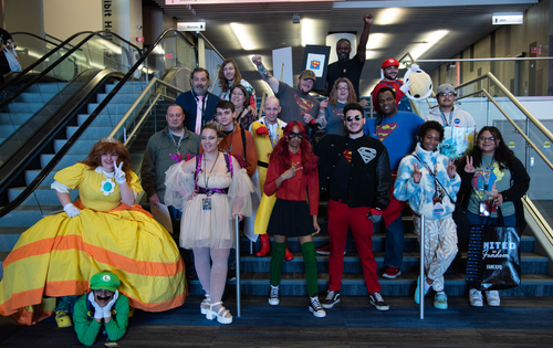 a group of cosplayers posing for a super group photo
