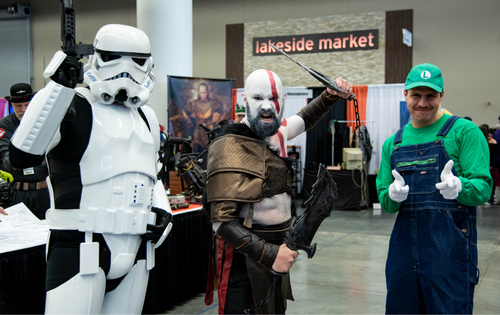 a group of 3 cosplayers, including a storm trooper and Luigi