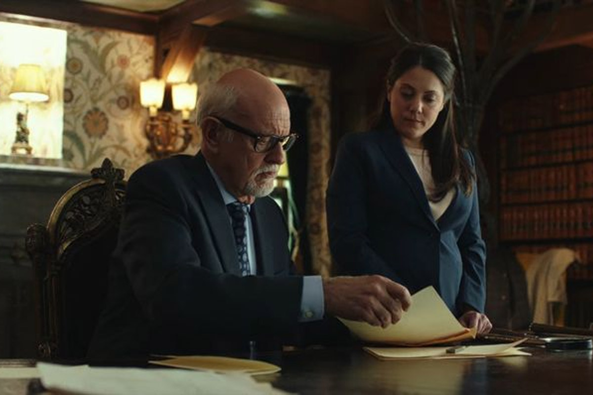 Frank Oz pulls a piece of paper from an envelope.