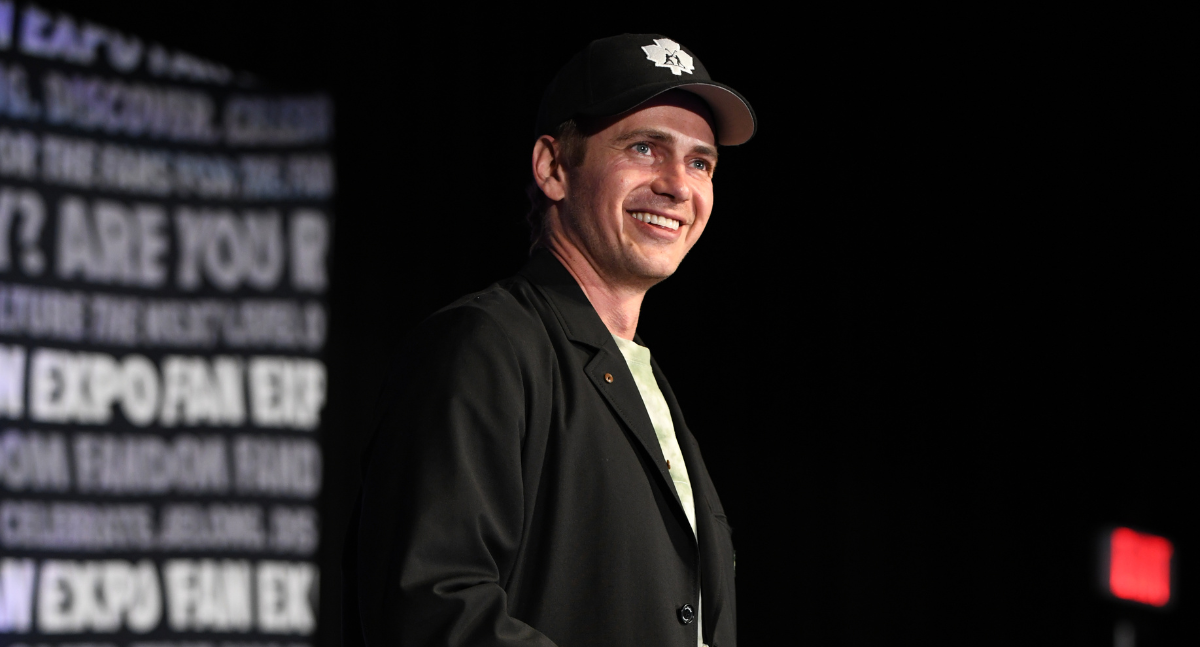 Hayden Christensen enters his panel and greets fans with a wide smile.