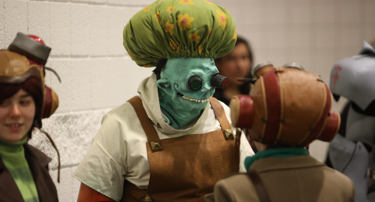 Dr. Loboto (Psychonauts) stand amongst a group of cosplays dressed as Razputin Aquato, the game's antagonist.