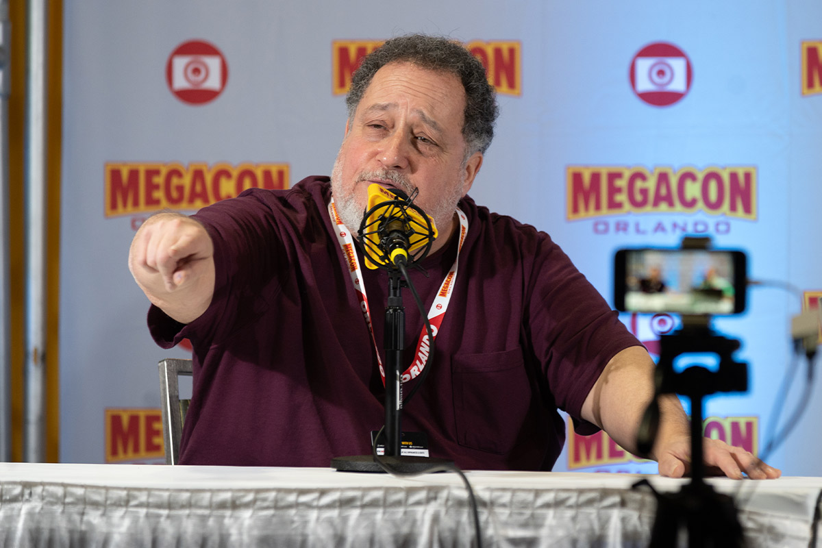 Marty Grabstein points off stage looking confused