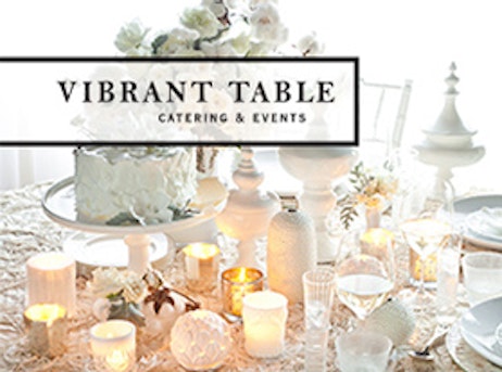 vibrant table catering & evets logo with white table setup
