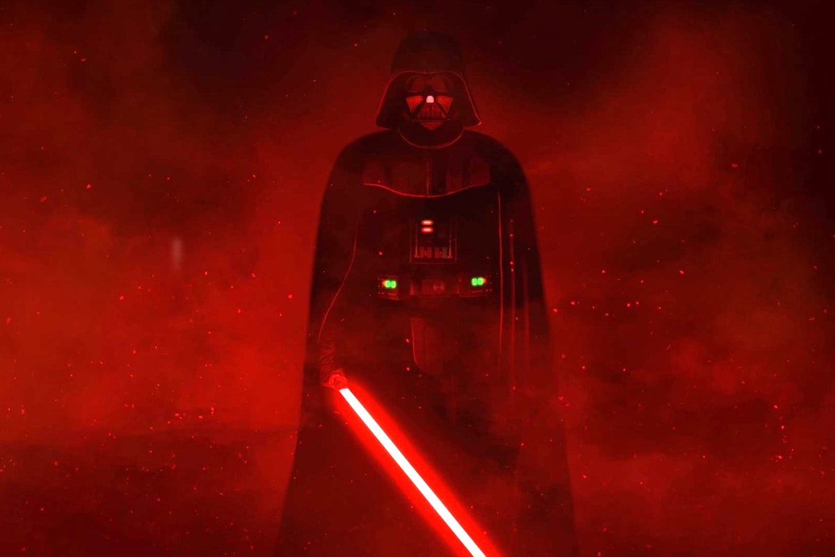Darth Vader in a dark room with smoke lit red around him holding an ignited red lightsaber