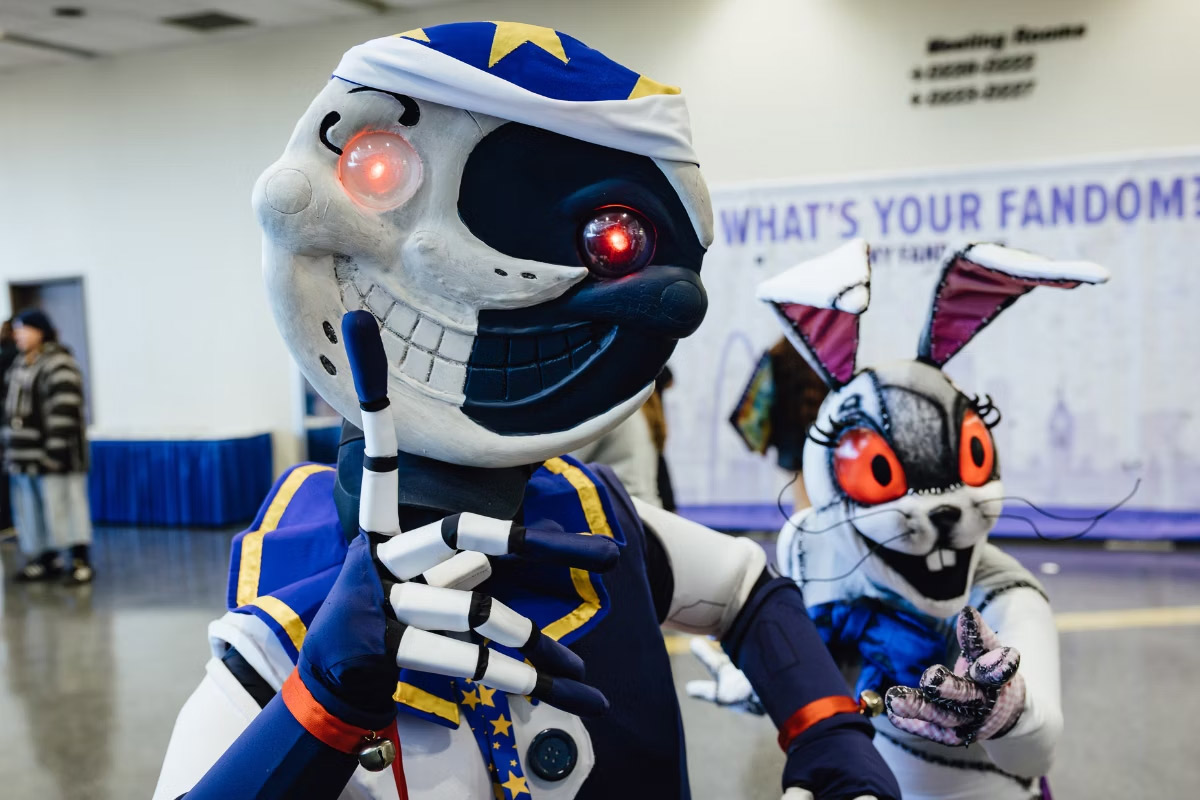 Cosplayers dressed as Moon & Vanny from FNAF: Security Breach pose for the camera