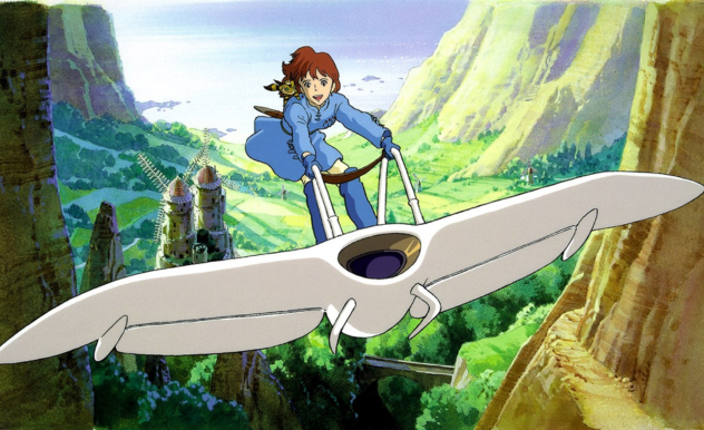 Nausicaä and Teto ride the mehve (a white glider style machine) away from the village and up towards the mountains. She wears a blue dress and blue leg warmers.