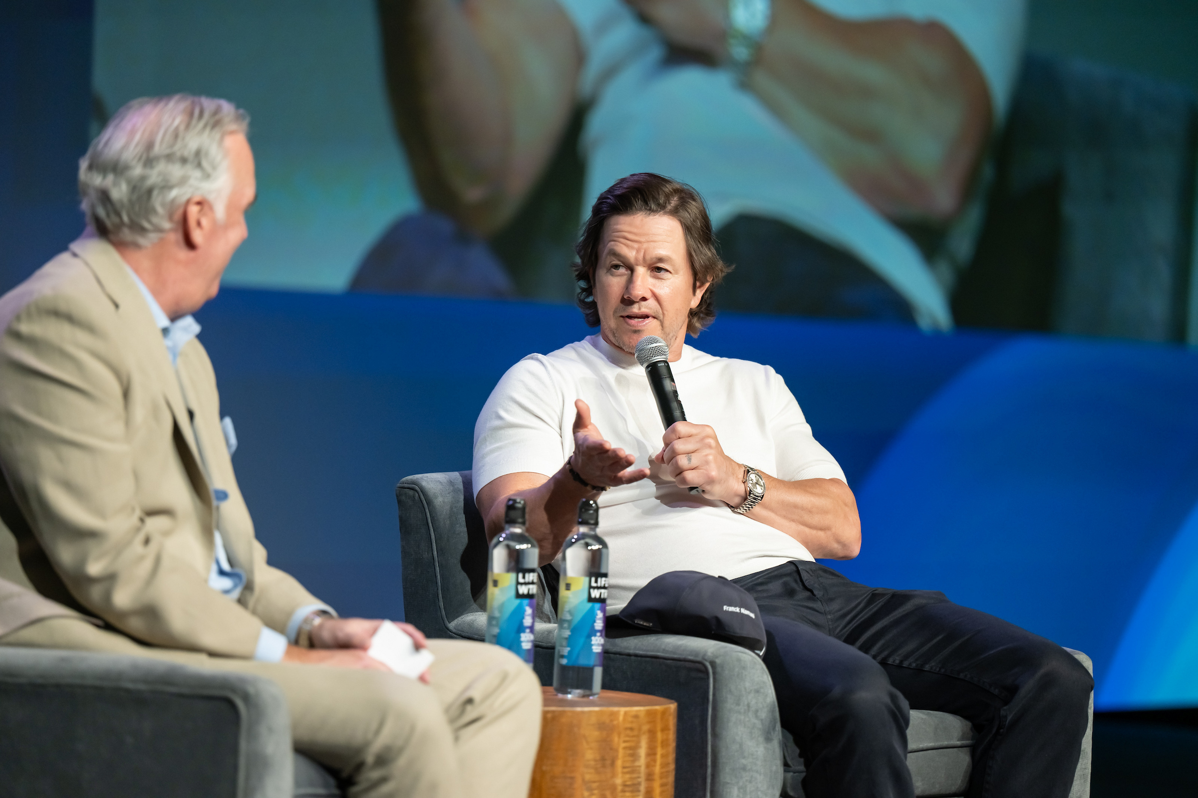 Mark Wahlburg talking on a microphone