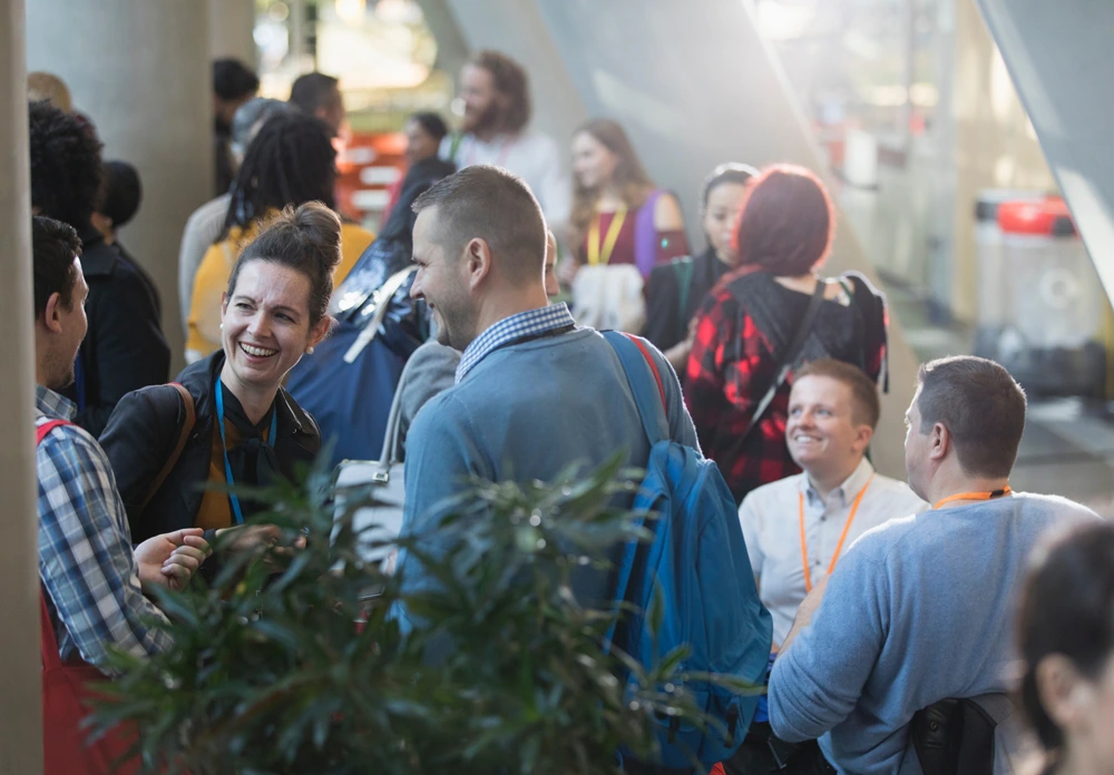 Photo of attendees mingling after a general session.