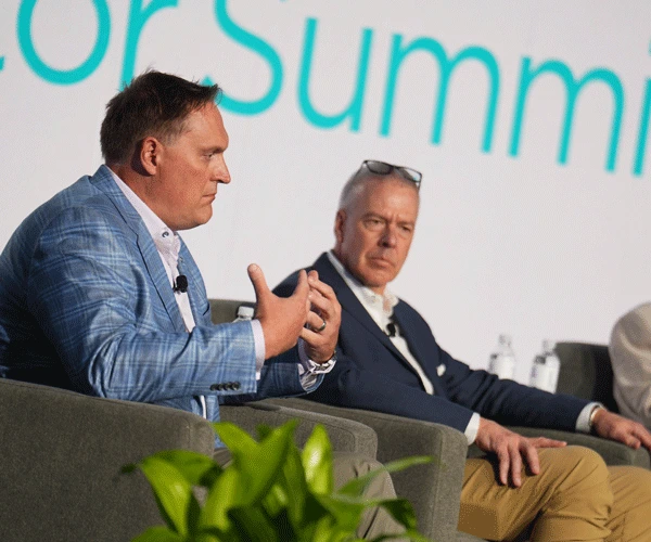 Prominent speaker onstage discussing investments at the Investor Summit