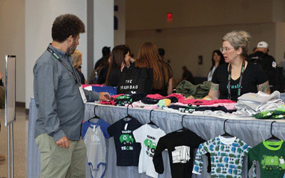 Attendee looking through Women's Council Boutique clothing options