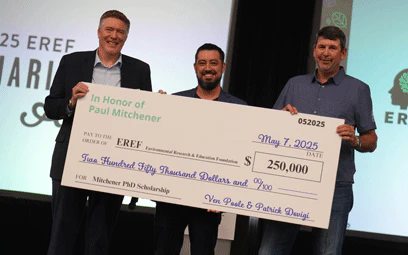 Large charity check presented onstage at the EREF Auction