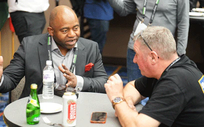 2 men chatting at the international reception