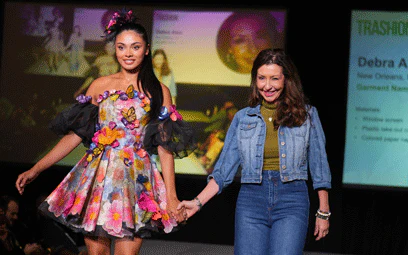Trashion model and designer walking the strage.