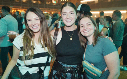 Group of 3 posing for photo at welcome reception