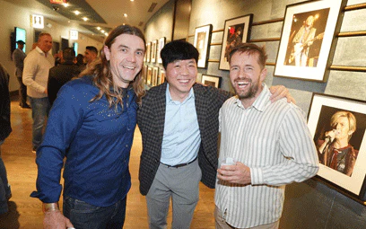 Group of 3 posing in the hallway of the welcome reception