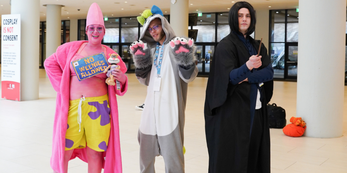 Patrick, a wolf, and their friend Snape met up on the main floor of the convention centre and smile for a photo