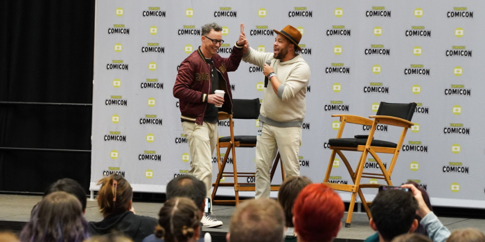 Tom Cavanagh smiles as he gets on stage, high fiving the moderator in front of a full and eager crowd