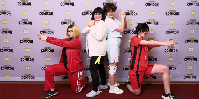 Teamwork makes the red carpet dream work! The Haikyu!! crew pose together. Left to right, one person is on one knee, pointing left, the dup in the centre are back to back, and the person on the right is on one knee, fingers pointing right.