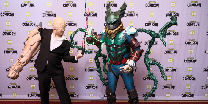 Heroes and villains strut the carpet together! This My Hero Academia duo of Muscular and Deku stand, prepared for battle, toward the camera.