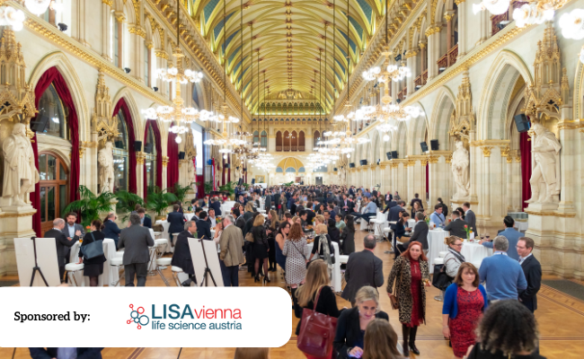 A picture of the inside halls of Vienna Rathaus (City Hall) with people networking inside