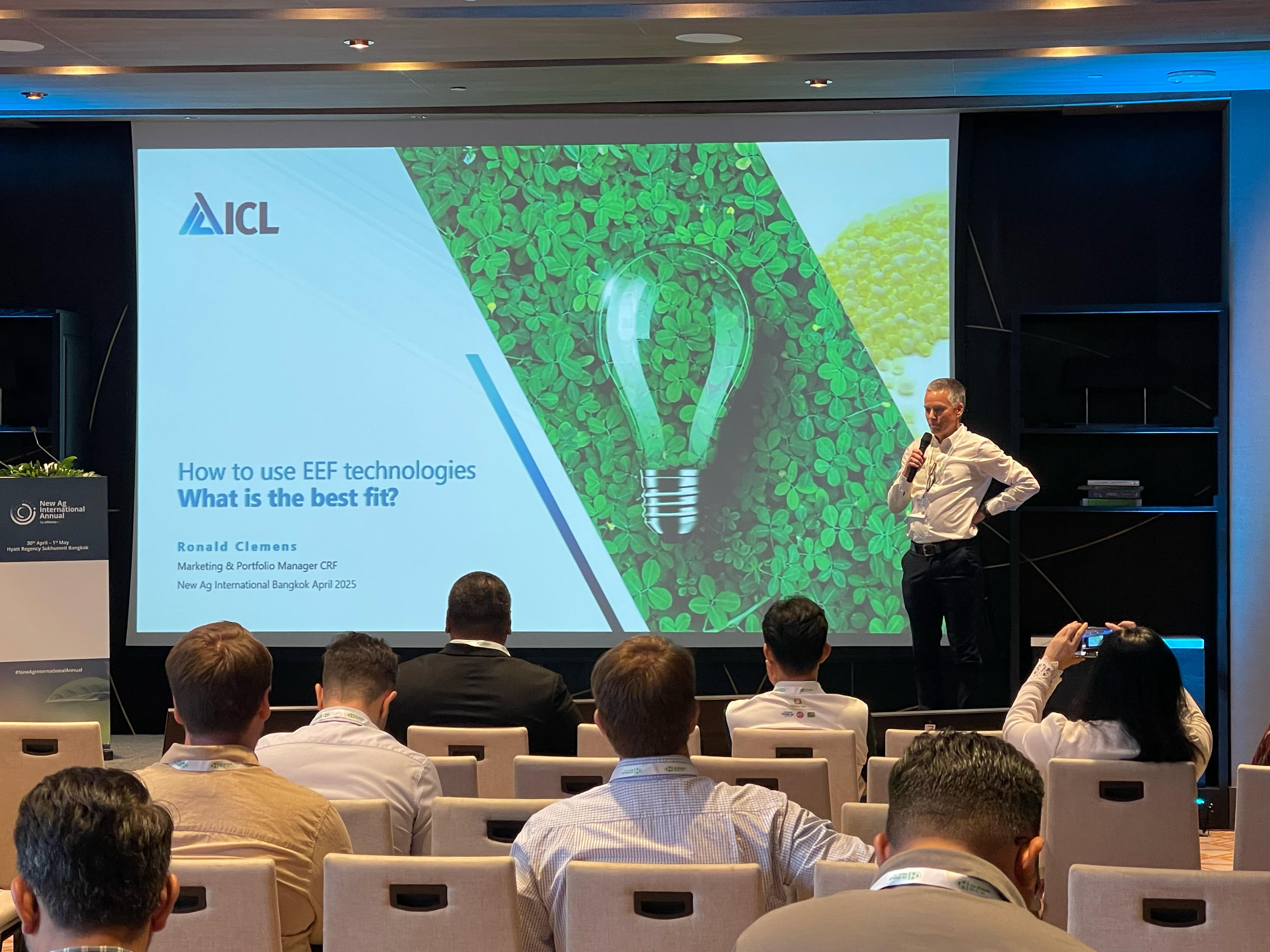 Speaker presents on stage at the New Ag International Annual, discussing innovations in specialty fertilisers and water-soluble solutions.