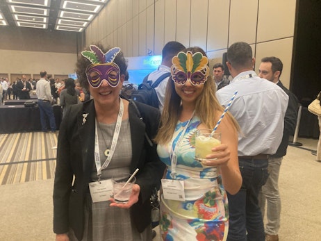 2 women with masks enjoying the evening reception at Biocontrol & Biostimulants LATAM
