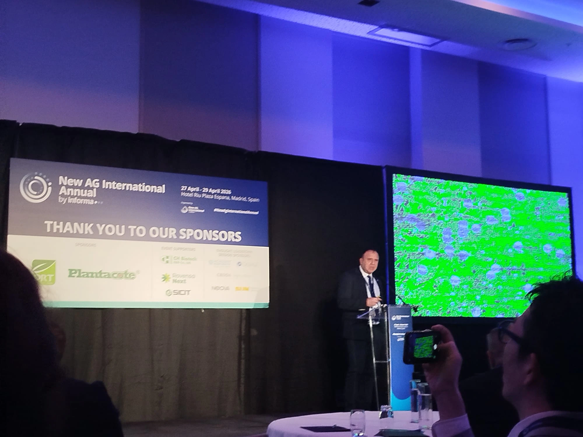 A speaker presents at the New Ag International Annual, discussing the future of specialty fertilisers and BioAg solutions.