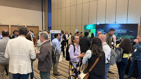 People networking in the exhibition area at Coffee LATAM