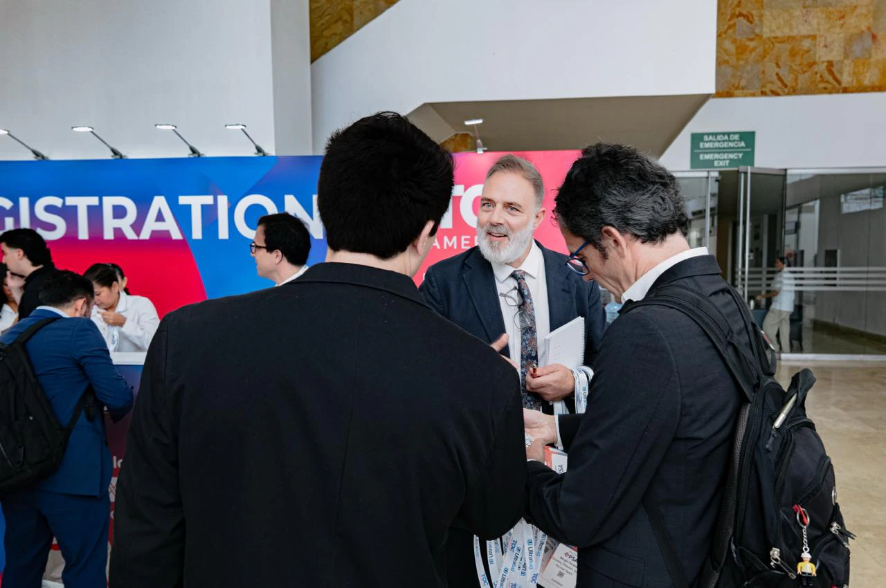 Participants registering at the event reception area.