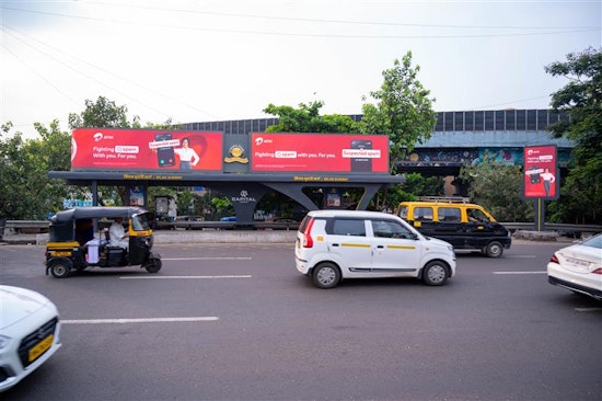 Modern movie theater auditorium with tiered blue reclining seats, atmospheric lighting, and large projection screen"