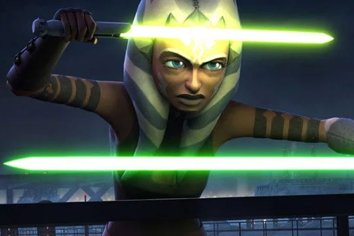 Ahsoka Tano with both lightsabers activated in front of her, with green on the bottom and the yellow/green on the top
