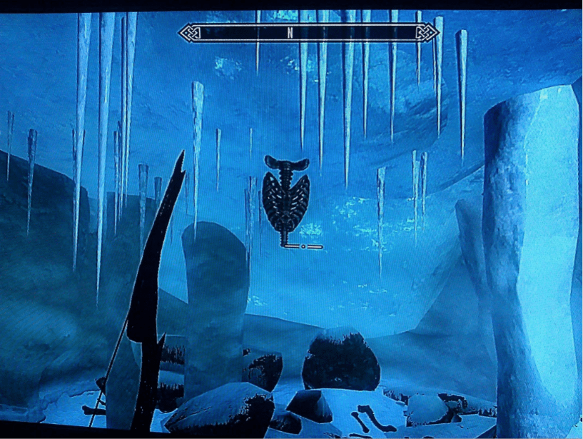 An ice cave with large icicles coming down from the roof