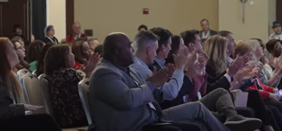 Audience clapping after presentation at PAP conference