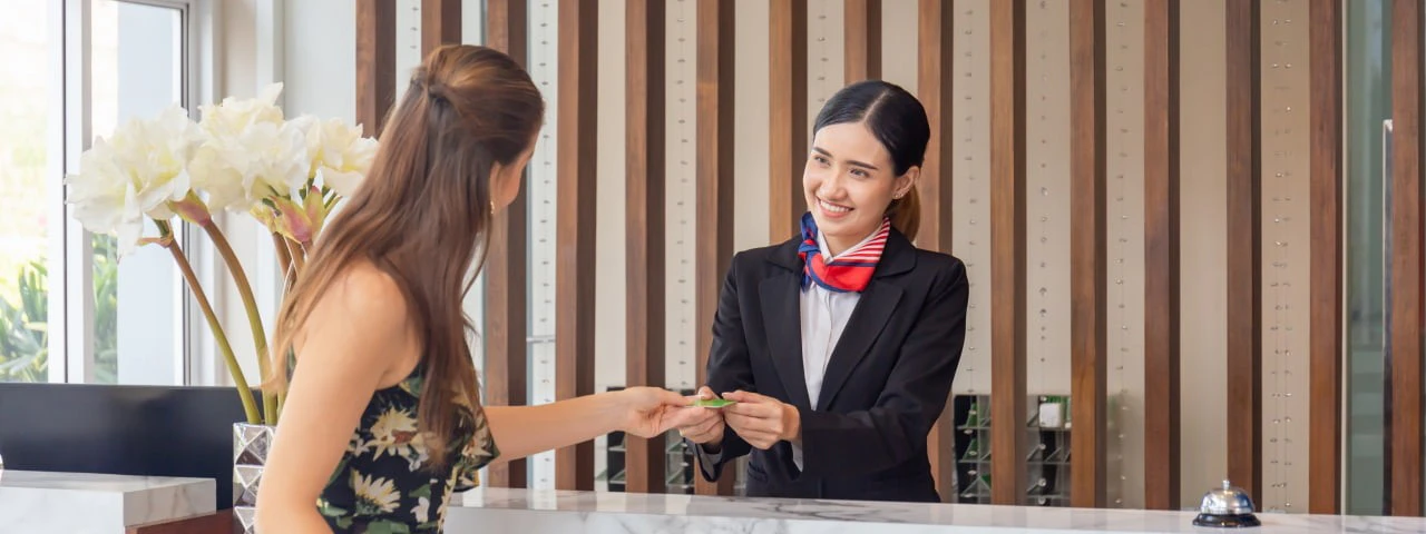 Woman checking in to a hotel