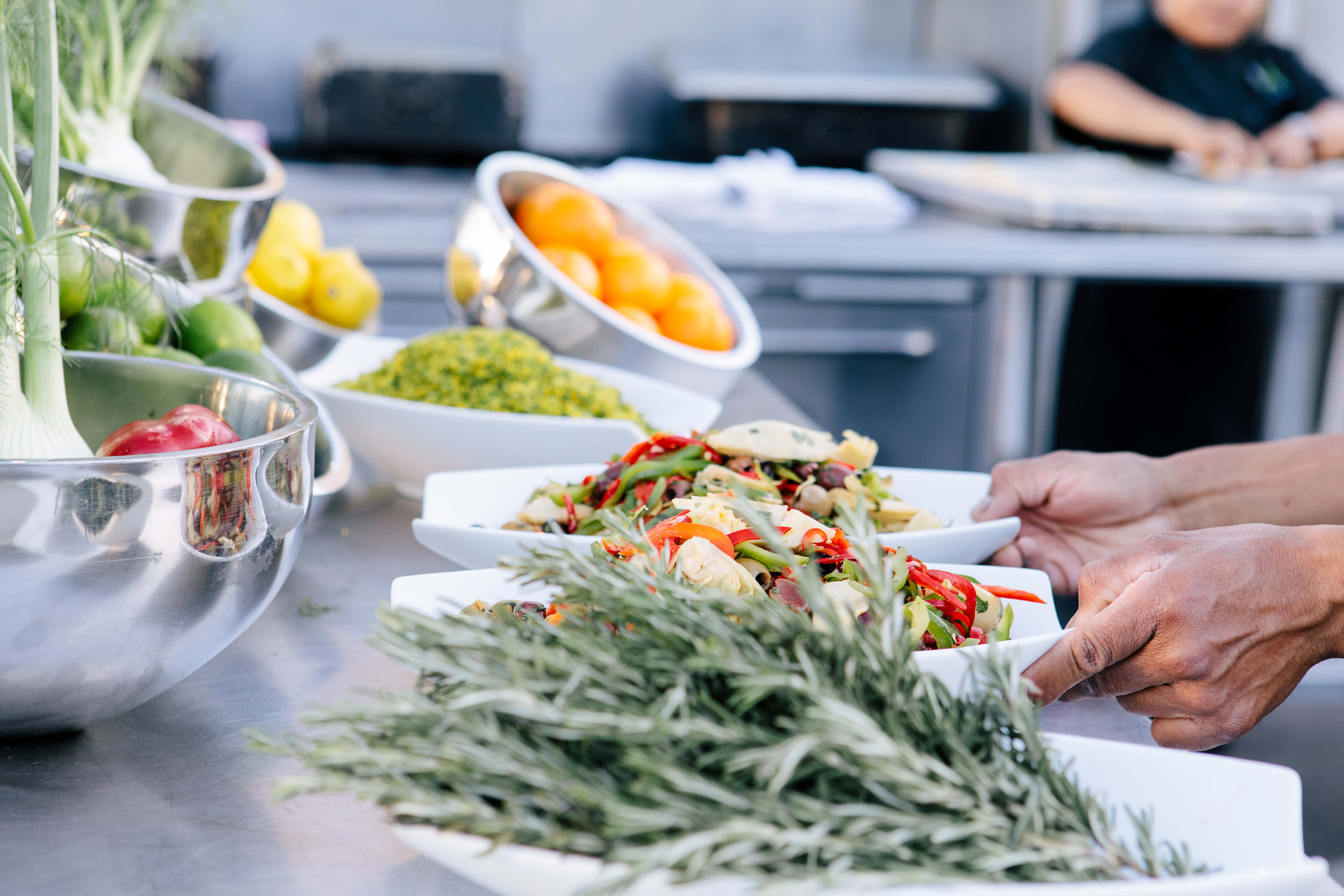 plates of rosemary, salad, oranges, lemons