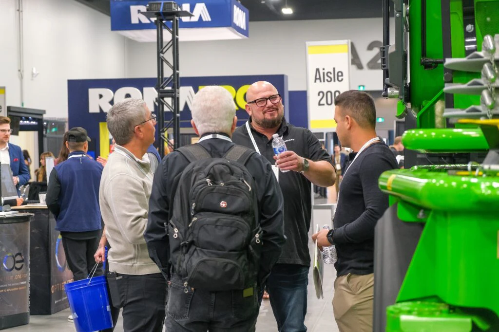 Attendees having a conversation nearby the RONA Pro booth at a BCG portfolio event.