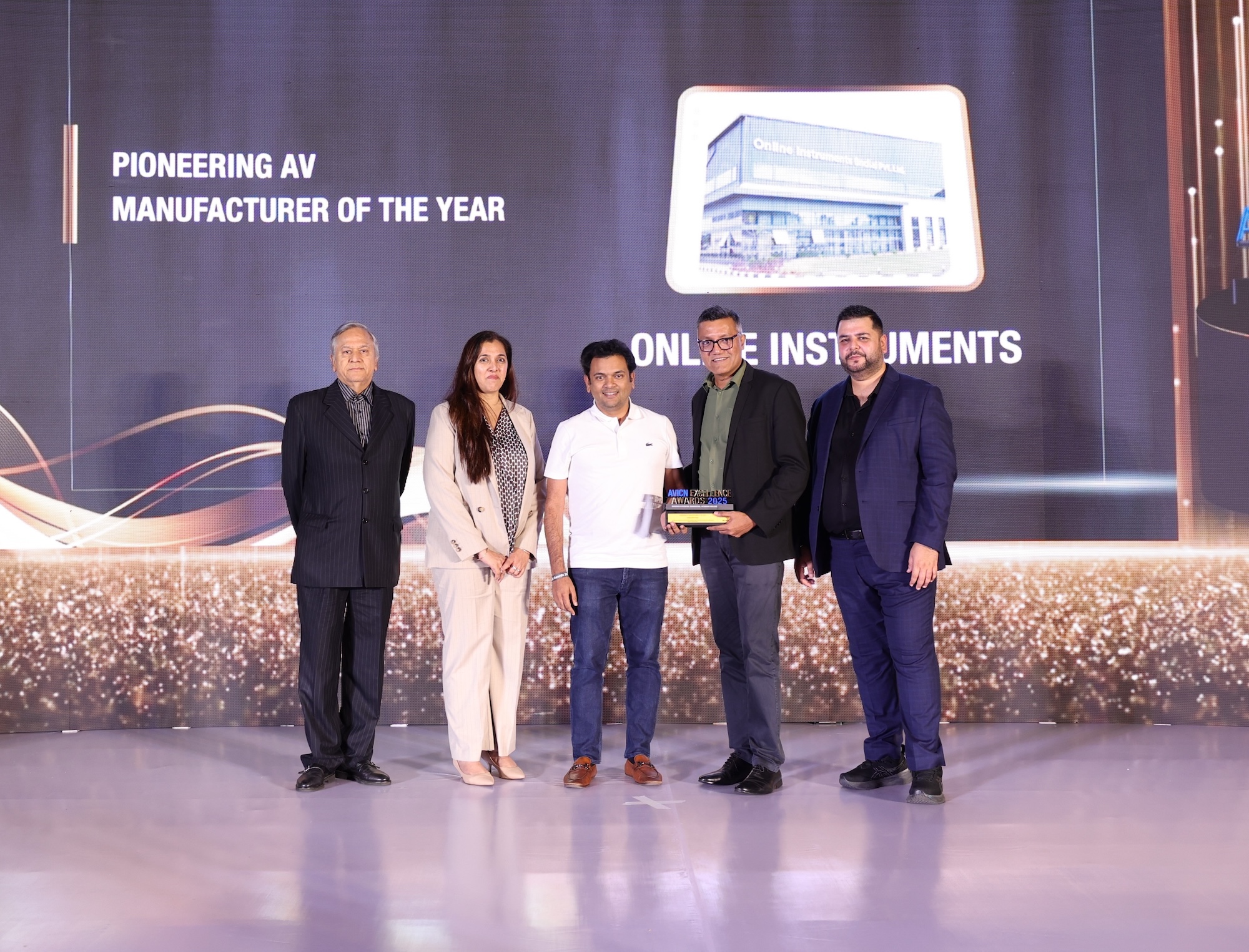 Group receiving an award at the Excellence Awards ceremony.