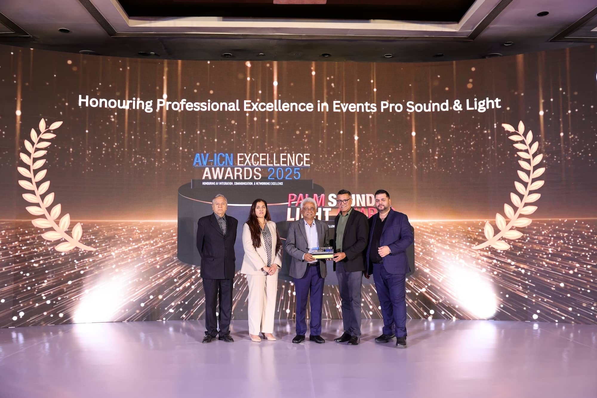 Group receiving an award at the AV-ICN Excellence Awards ceremony.