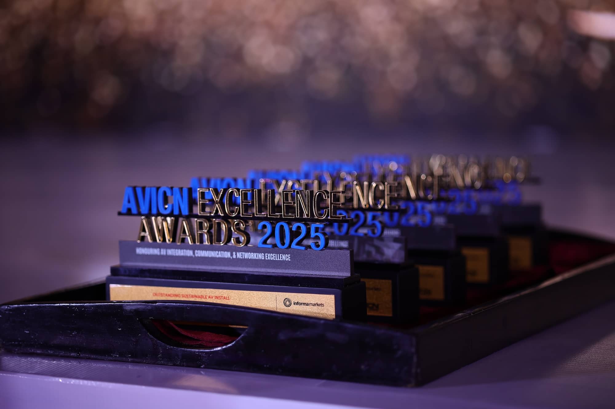 Several AV-ICN Excellence Awards trophies displayed on stage
