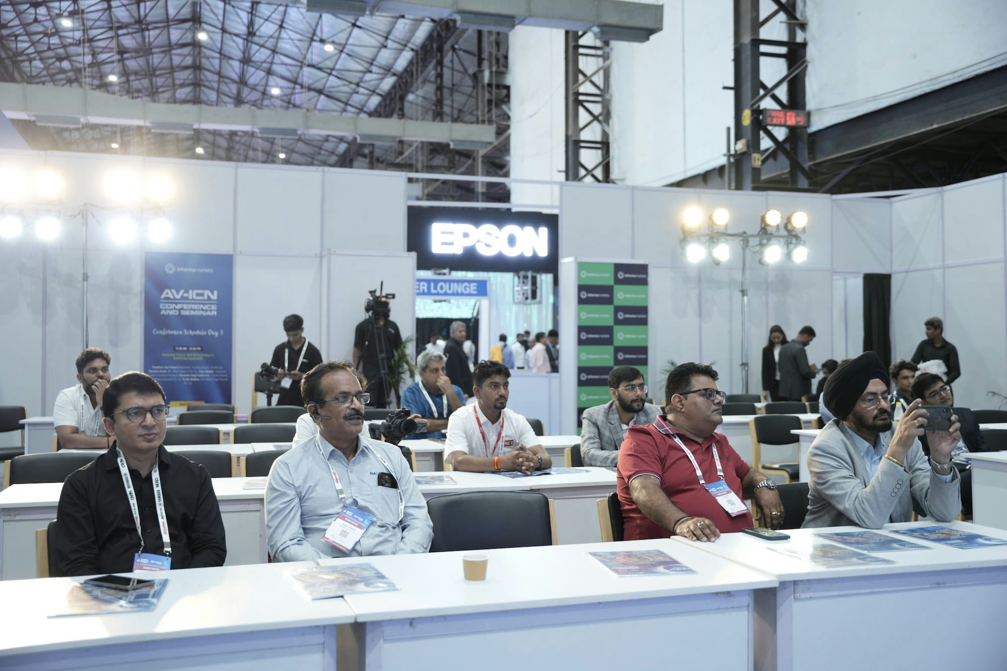 Attendees seated at a technology conference with Epson branding visible in the background.