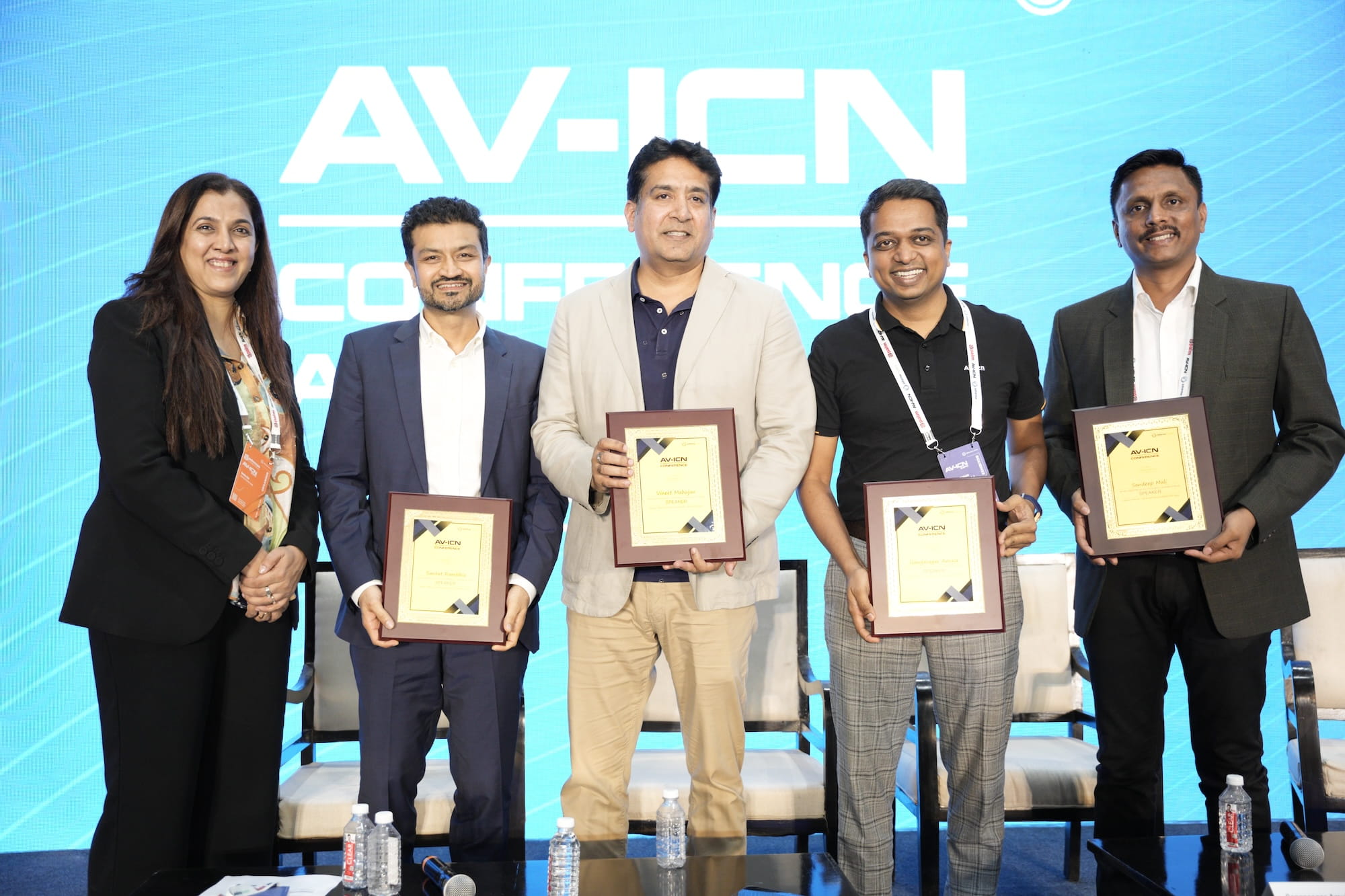 Group of professionals receiving awards at an AV-ICN conference.