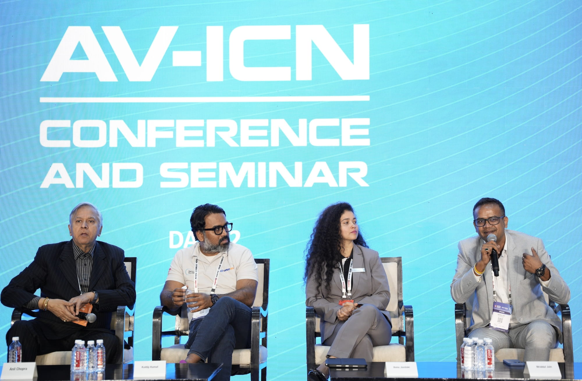 Panel discussion at AV-ICN Conference and Seminar with four speakers seated on stage.
