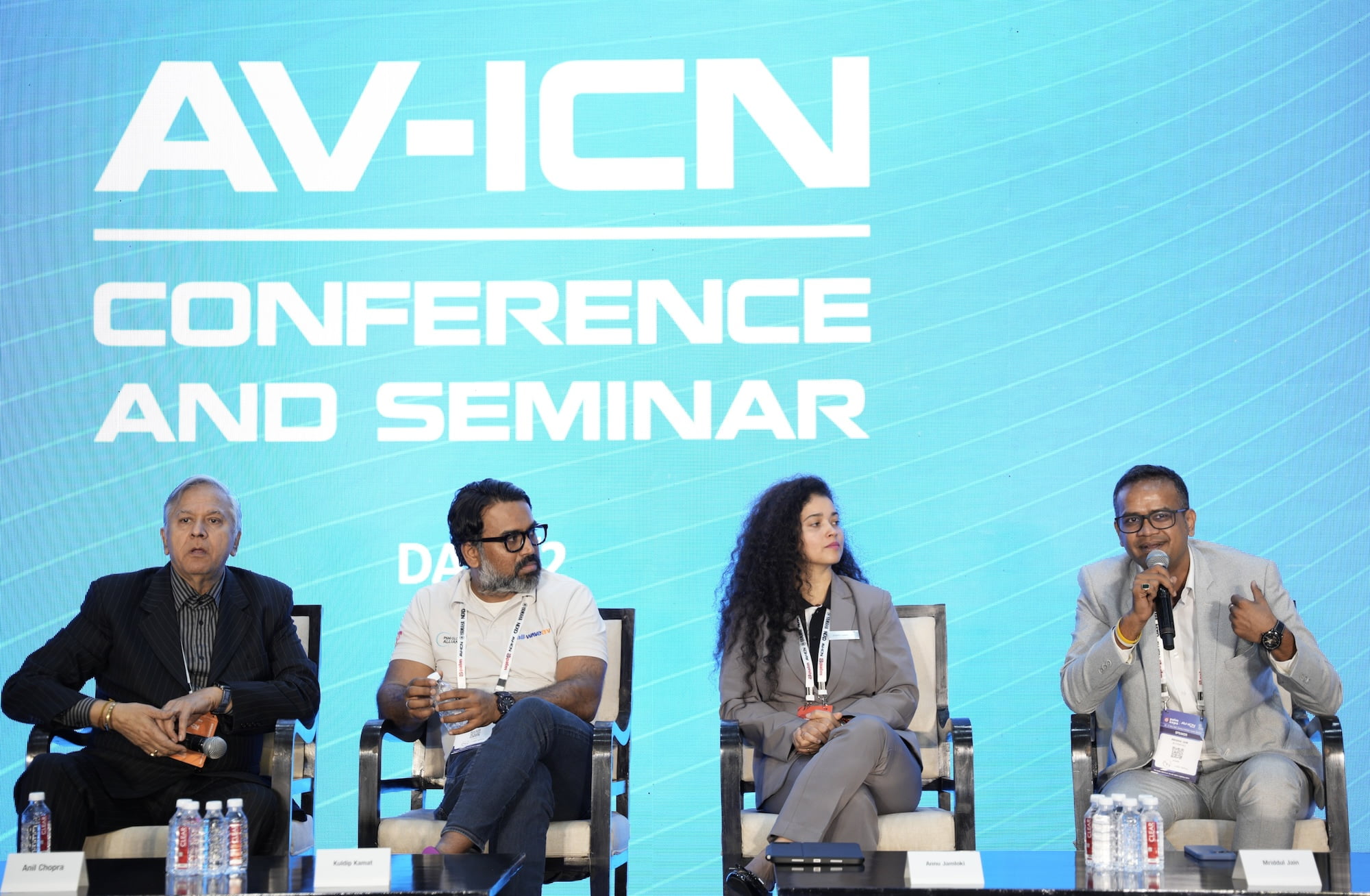 Panel discussion at AV-ICN Conference and Seminar with four speakers seated on stage.